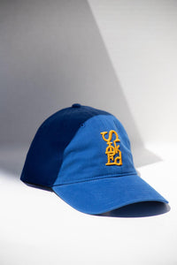 Blue cap with yellow logo on a white background